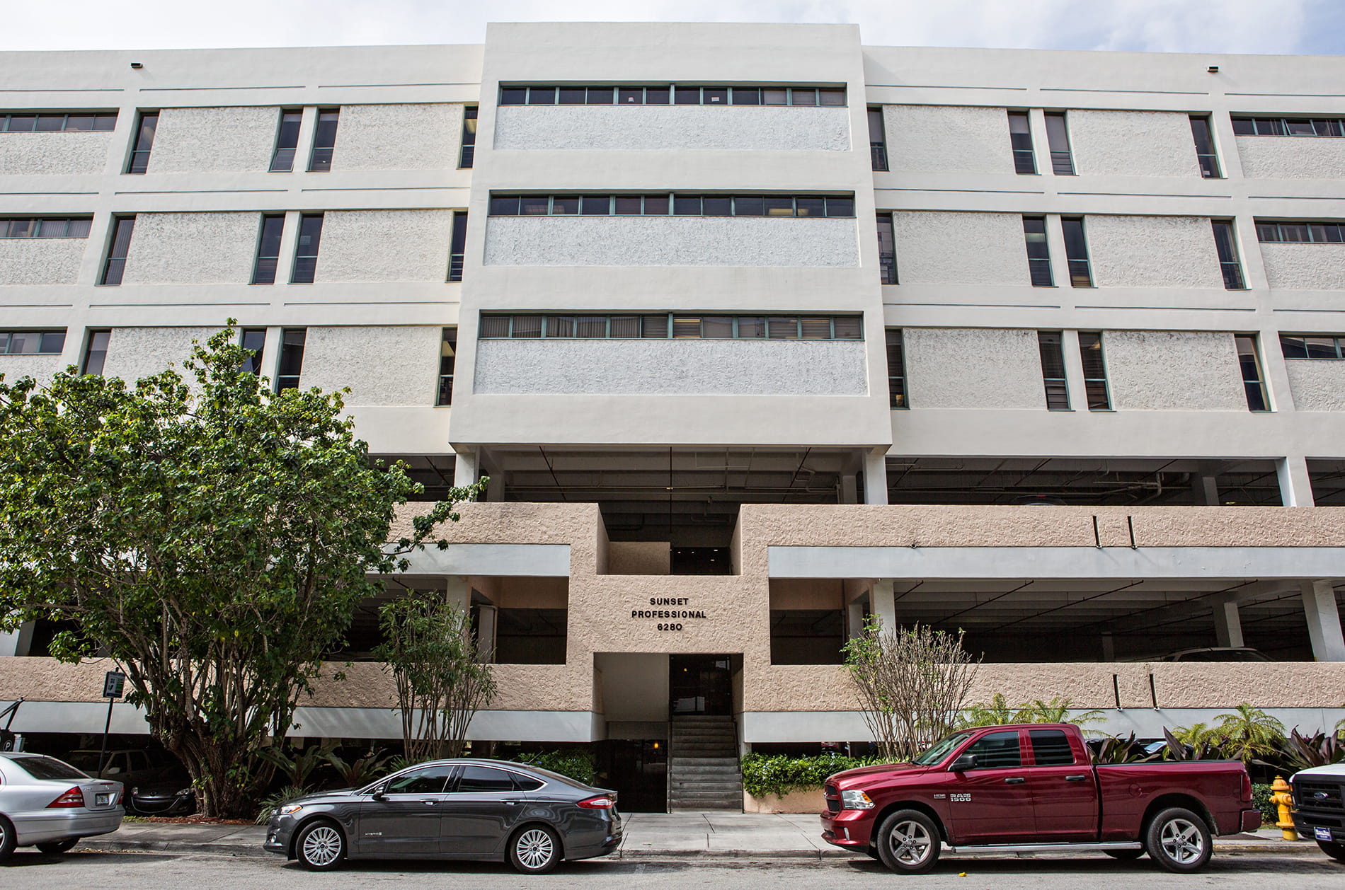 Front of the Sunset Professional Building at 6280 Sunset Drive, with the main entrance and stairs at center